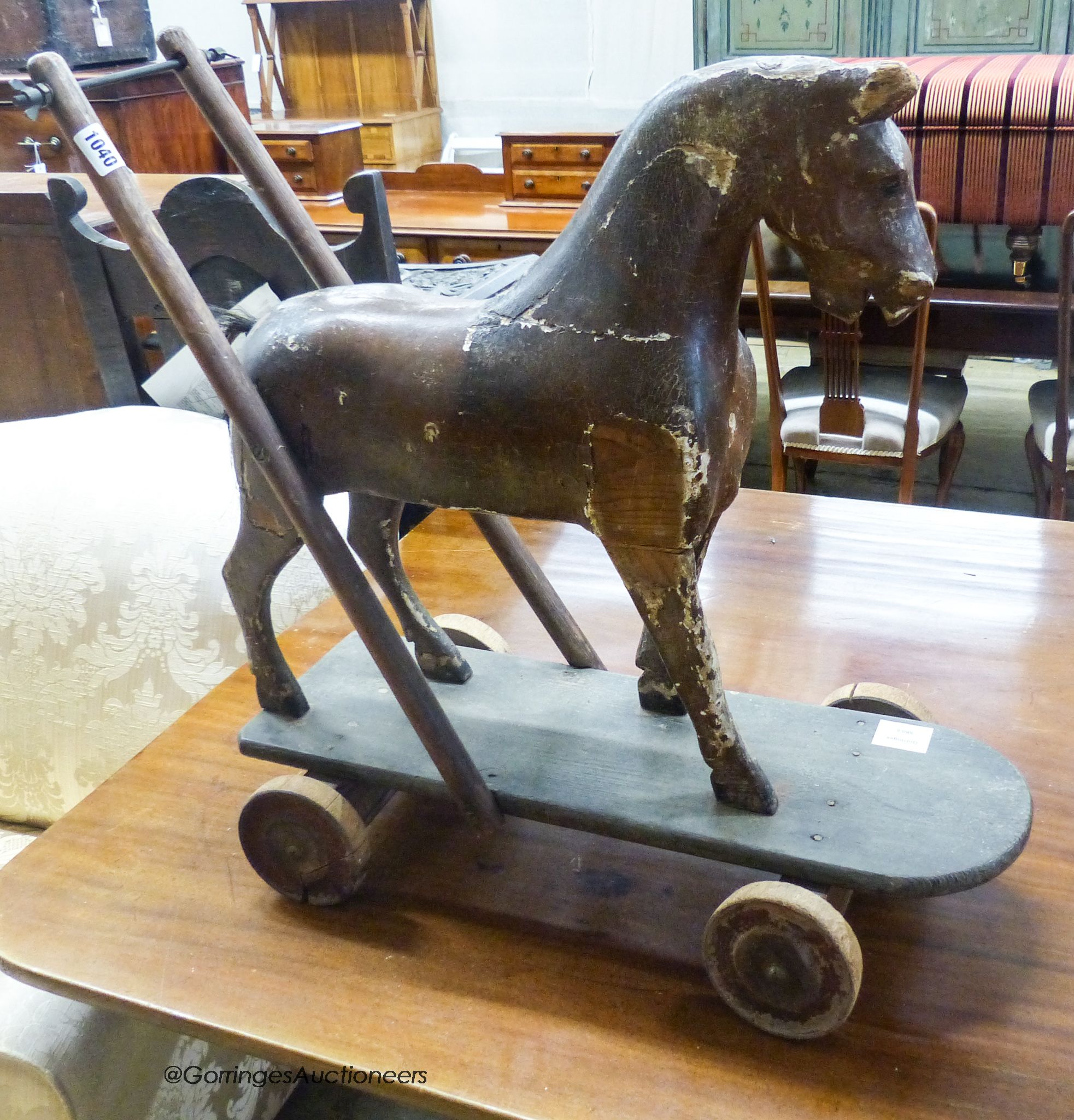 A Victorian painted push along toy horse, width 60cm